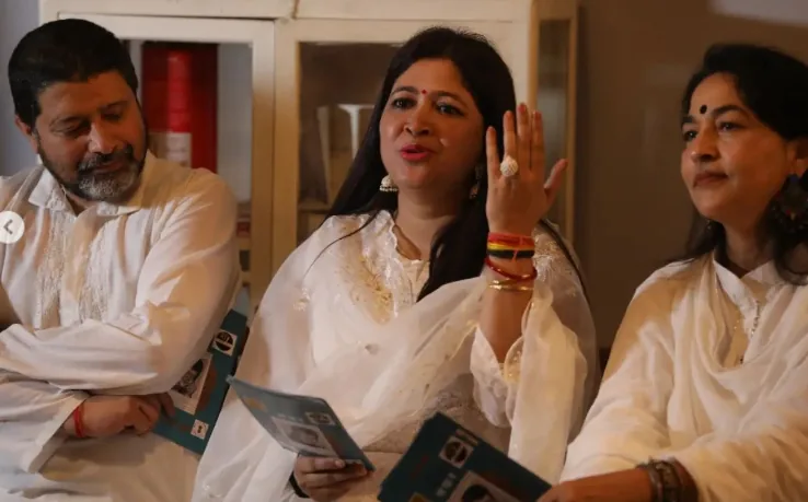 Panelists in conversation holding festival programme booklets